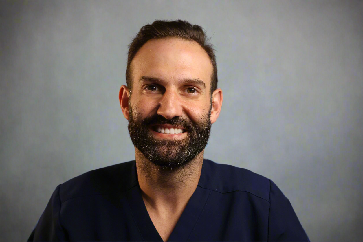 dr justin emami in front of a gray background